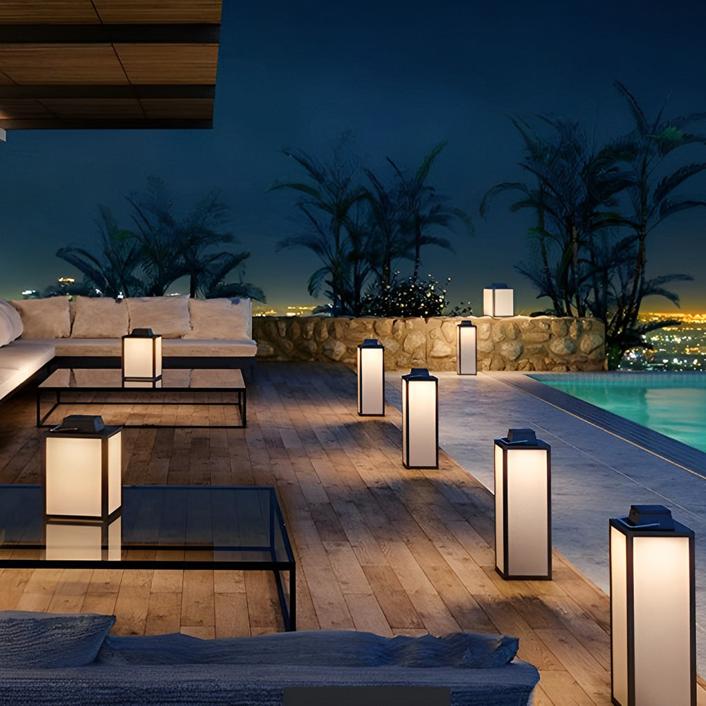 Square lantern giving soft light on a poolside deck