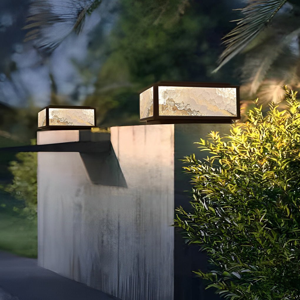 Square pillar light on a concrete column in a garden