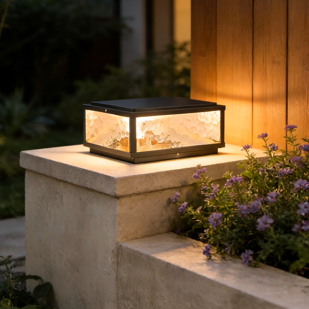 Square pillar light on a stone column by an exterior wall