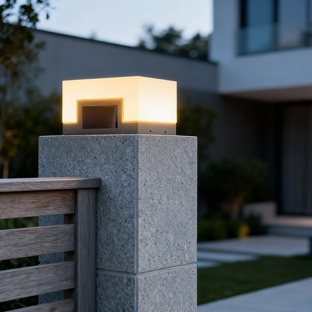 Square solar lawn light mounted on a concrete post