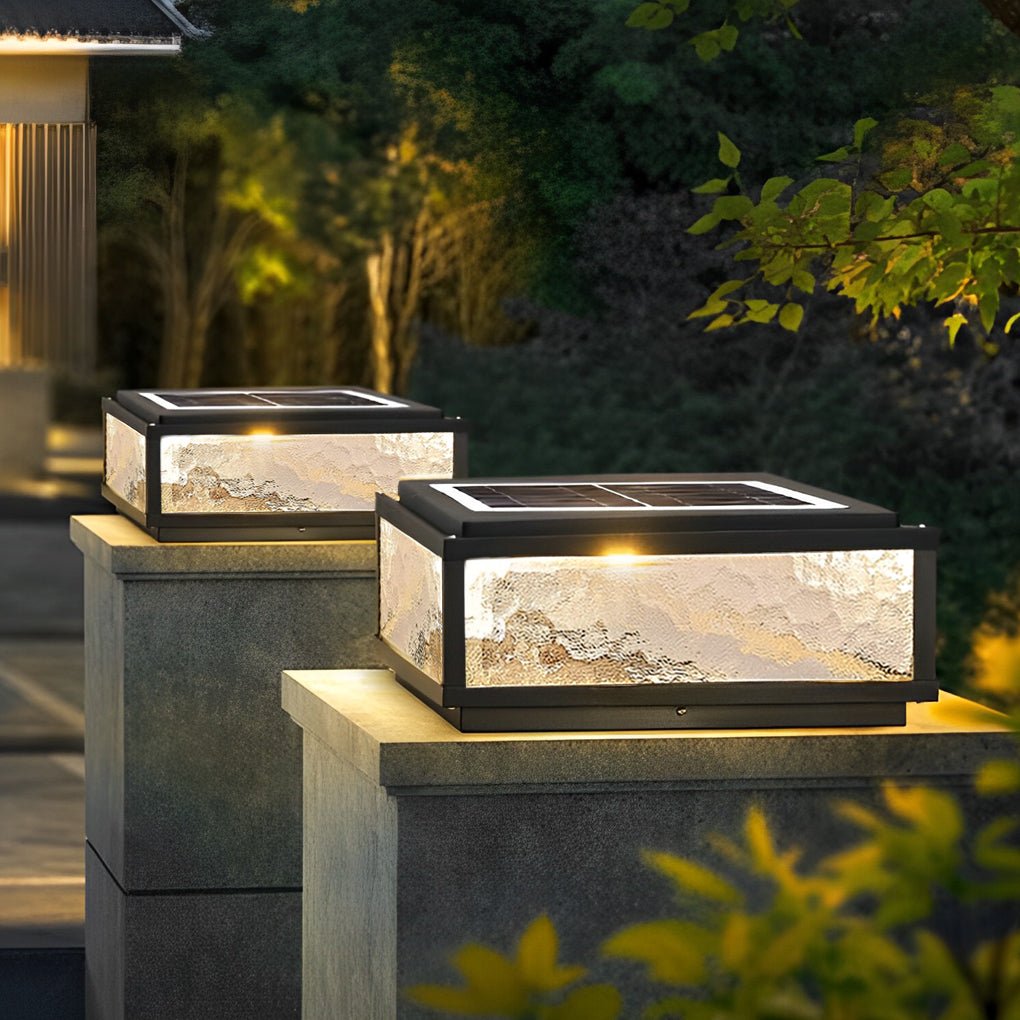 Square solar pillar light in a landscaped garden