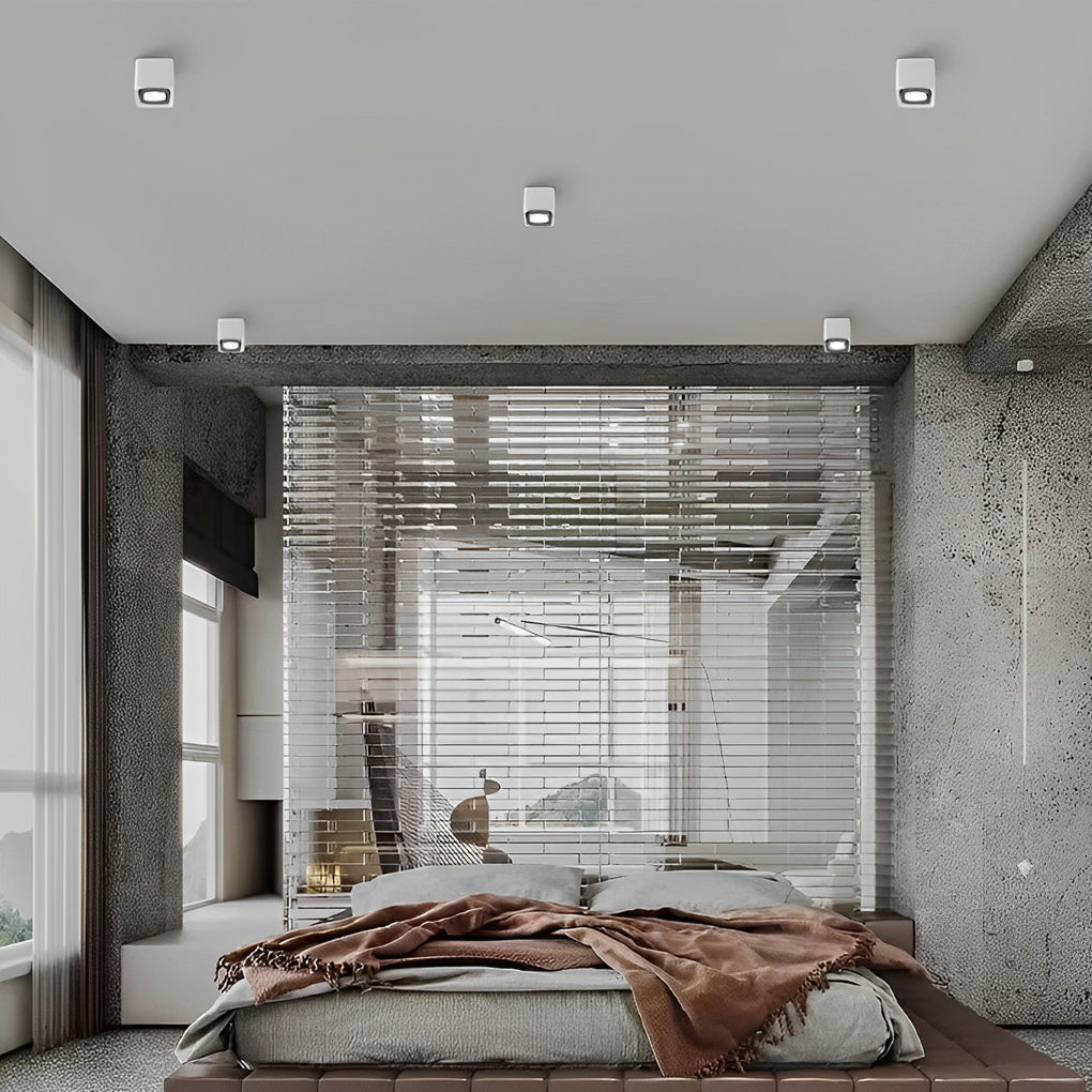 Square white grid spotlight mounted on a plain ceiling