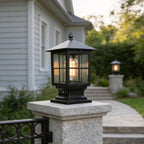 Black column lantern on a granite column beside a garden path