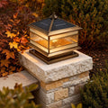 Brass pillar lantern on a garden column at dusk