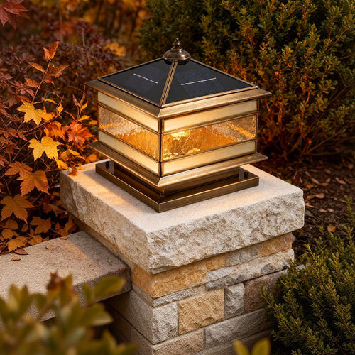 Brass pillar lantern on a garden column at dusk