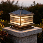 Brass pillar lantern standing in a landscaped yard outdoors