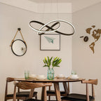 Stylish mobius ring pendant light above a dining table