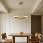 Gold finish round chandelier in a modern kitchen dining space