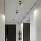 Multiple surface spot lights along a hallway ceiling