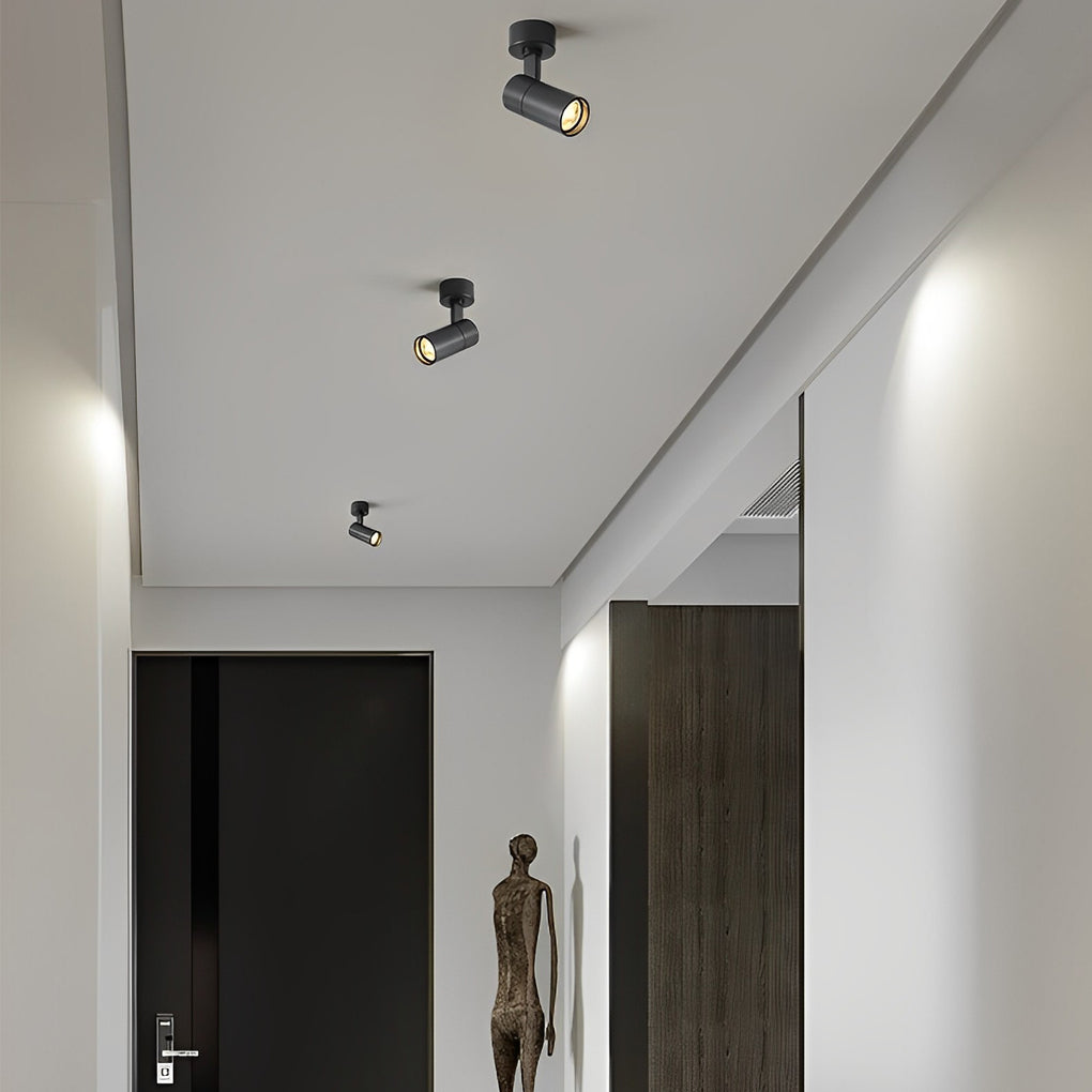 Multiple surface spot lights along a hallway ceiling