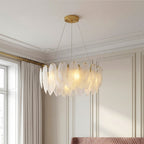 Tiered gold feather chandelier with frosted glass shades