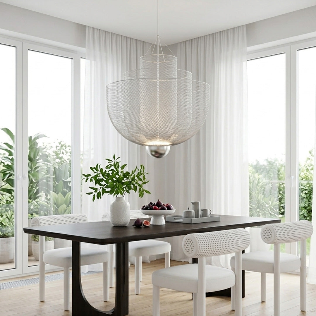 Tiered mesh chandelier above a dark dining table with garden view