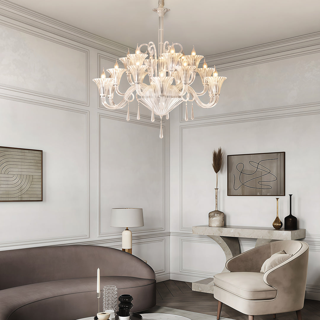 Art glass chandelier in a white living room with a grey sofa