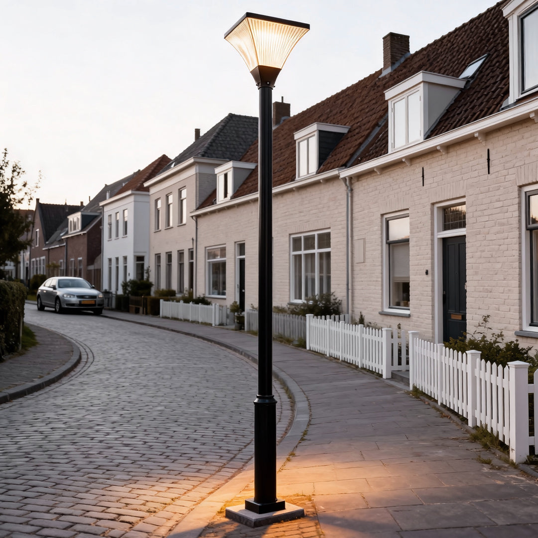 Street lamp on a cobblestone residential street at night