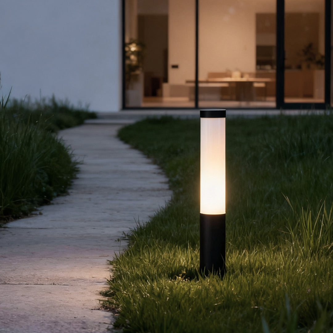 Tube lights giving soft glow along a curved garden path