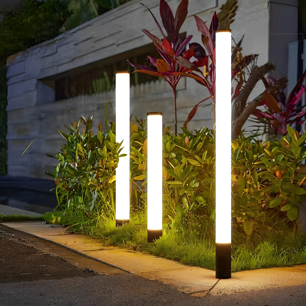 Group of three tube lights in a stylish garden landscape