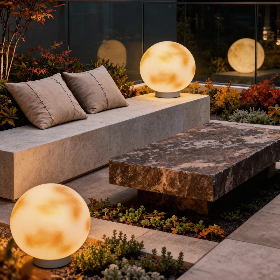 Two moon globe pillar lights on a contemporary patio
