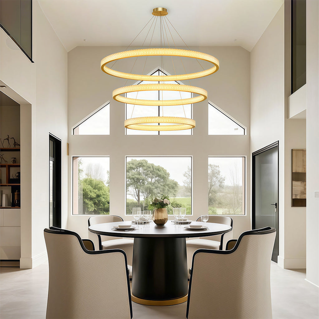 Crystal chandelier above a round table with upholstered chairs
