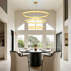 Crystal chandelier above a round table with upholstered chairs