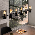 Linear glass pendant chandelier shown against a wall
